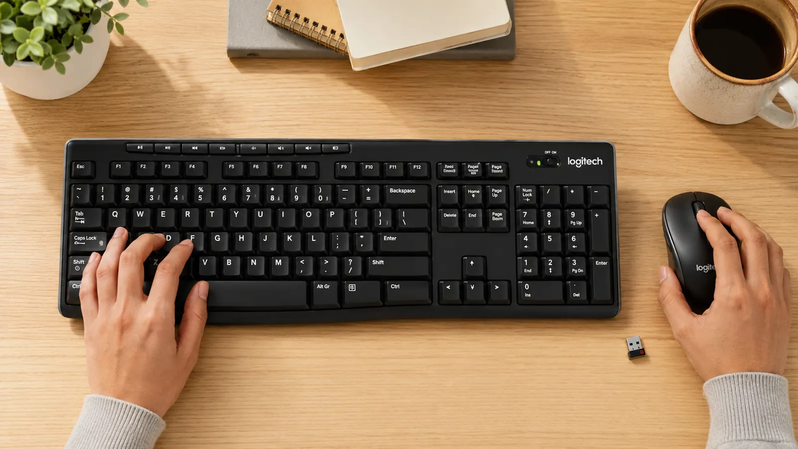 Logitech MK270 wireless keyboard and mouse side by side on a desk with the small USB nano receiver placed beside them