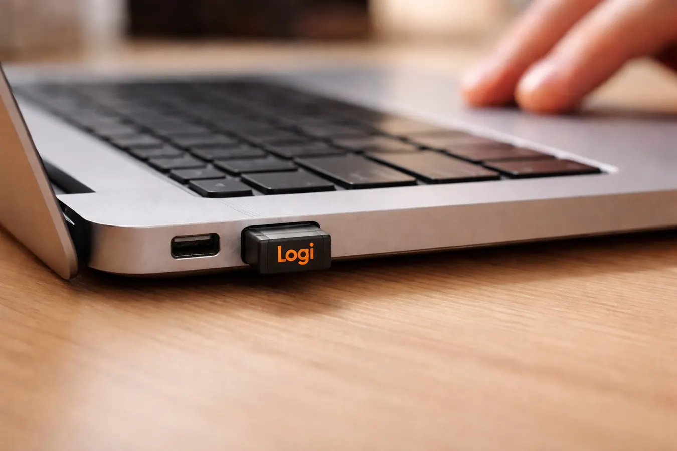 Logitech MK270 USB nano receiver plugged into a laptop USB-A port showing its small size